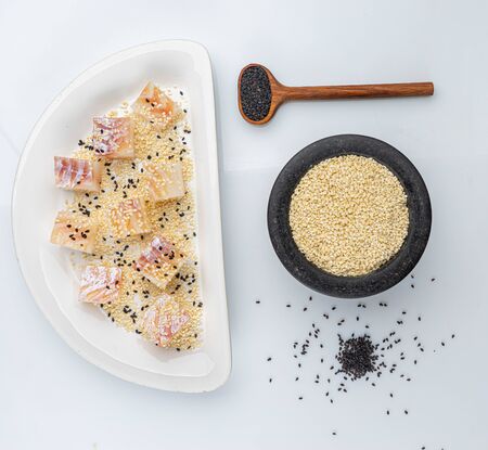 chopped cod with sesame seeds on whiteの写真素材