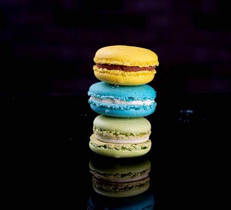 assorted macarons cakes on black backgroundの写真素材