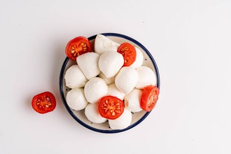 mozzarella in white bowl on whiteの写真素材