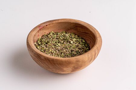 herbs in wooden bowl on whiteの写真素材