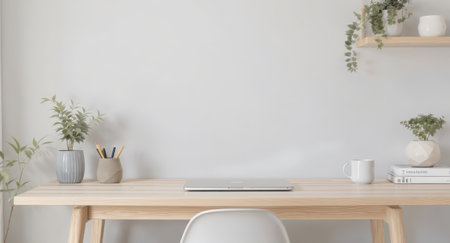 A bright and inviting minimalist home office setup, showcasing a light wooden desk against a pristine white wall. A closed silver laptop rests centrally on the desk, symbolizing modern productivity and remote work. Various potted green plants in ceramic vases adorn the desk and a floating wooden shelf above, adding a touch of nature and freshness to the serene environment. A clean white chair is positioned in front of the desk, ready for use. Other decorative elements include a stack of books and a white mug, contributing to the clean, Scandinavian-inspired interior design. The scene conveys a sense of calm, focus, and contemporary living, ideal for study, creative work, or professional tasks.の素材