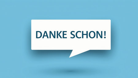 This graphic illustration features a white speech bubble containing the German phrase DANKE SCHON! which translates to Thank You Very Much! or simply Thank You. The text is rendered in a dark grey, sans-serif font, providing clear readability. The speech bubble itself has a subtle drop shadow, creating a sense of depth and separation from the flat, light blue background. This minimalist design effectively conveys gratitude and appreciation, making it suitable for various communication contexts, digital interfaces, or acknowledgment messages in web design, applications, or educational materials.の素材