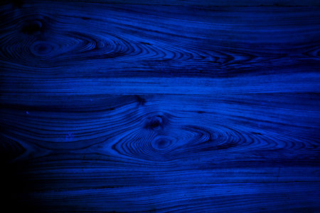 A captivating deep blue wooden surface enhances the atmosphere of a creative space, radiating serenity and inspiration. The intricate grain patterns invite exploration.の写真素材