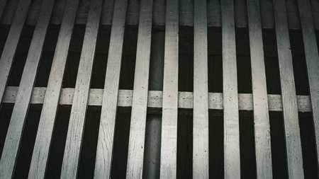 Patterns of wooden slats create a captivating design filled with light and shadow. Each slat tells a story, reflecting both nature and craftsmanship in harmony.の写真素材