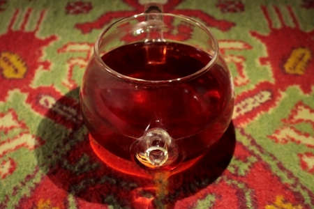 Glass teapot with tea on an oriental rugの写真素材