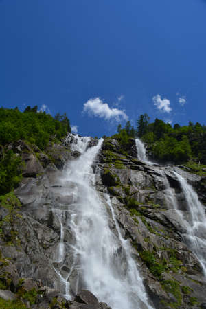 beautiful waterfall with trees and blu sky in trentino travel destinations no people copy spaceの写真素材