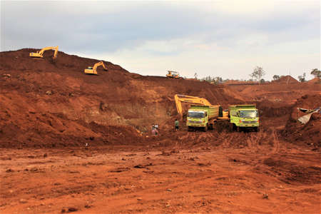 Pomalaa, Indonesia - June 19, 2011: Open nickel mining activity by clearing land using heavy axle...