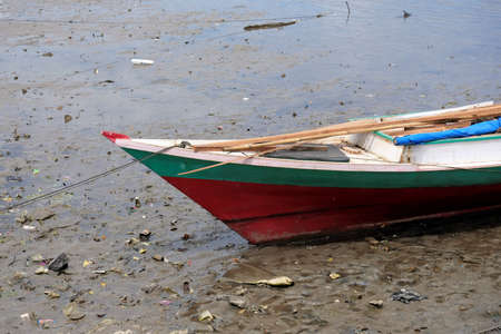 A fishing boat parked on the beachの写真素材