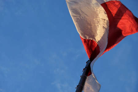 Flag on top of a flying poleの写真素材
