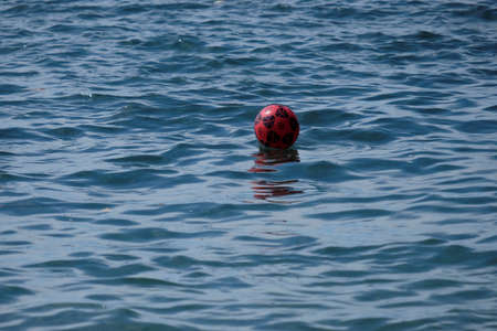 A ball above sea water