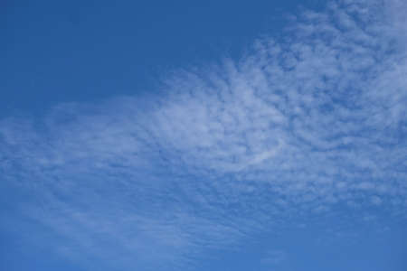 Photo of blue sky with tiny little white clouds