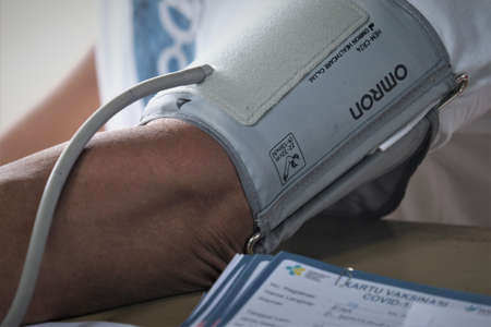 Kolaka, Indonesia, July 30, 2021: A potential recipient of the vaccine is undergoing screening