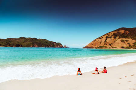Kids are Relaxing and Playing Sand in White Sand Beachの写真素材