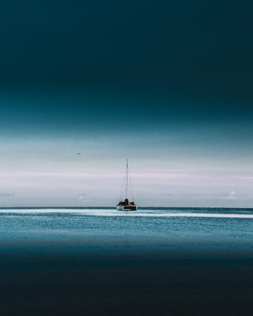Sailing boat in the sea at sunset. Long exposure photo.の写真素材