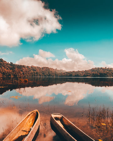 Boat on the lake with blue sky and cloud - vintage filterの写真素材