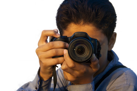 Caucasian boy isolated on white holding point and shoot camera.の写真素材