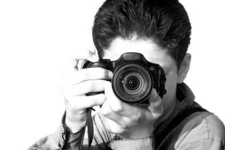 Caucasian boy isolated on white holding point and shoot camera.の写真素材