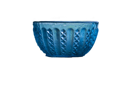 Antique glass bowl on the shinning surface,with blurred background, isolated, selective focus, shallow depth of field.の写真素材