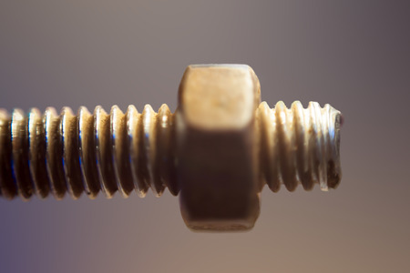 Close up of Nut Bolt with blurred background, isolated, selective focus, shallow depth of field, concept of hard work & industries.の写真素材