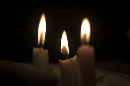 Lighted Candles with dark background, isolated, selective focus, shallow depth of field, concept of romance, love, religion & peの写真素材