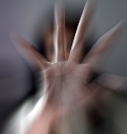 A girl trying to stop the camera to shot by getting her hand against it .の写真素材
