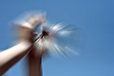 Hand in sky shot with motion blur effect.の写真素材