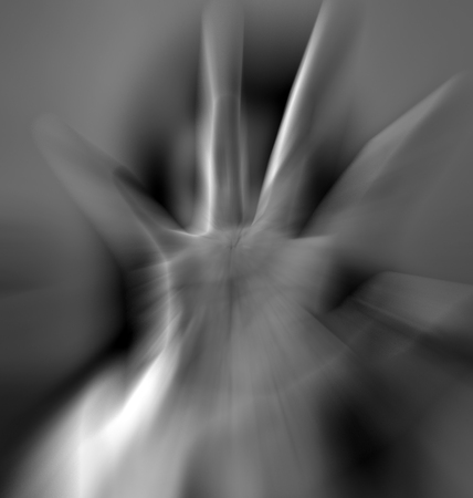 A girl trying to stop the camera to shot by getting her hand against it .の写真素材