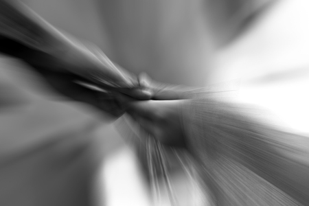 Human hands holding each other. shot with motion blur.の写真素材