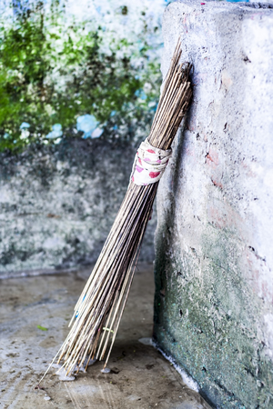 A wooden sticks broom on wet surfaceの写真素材