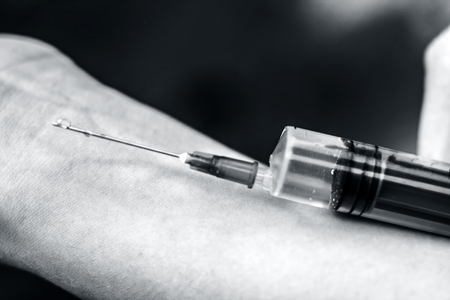 Medical syringe in a Nurse's hand.の写真素材