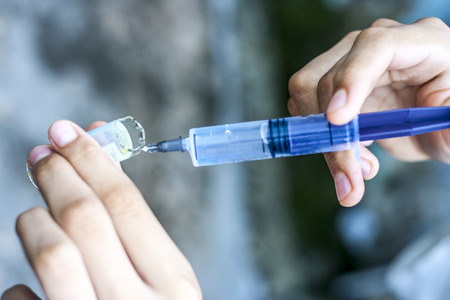 Syringe, medical injection, bottle, ampule in hand, palm or fingers. Medicine plastic vaccination...