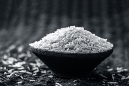Uncooked White Basmati rice in a clay bowl.の写真素材
