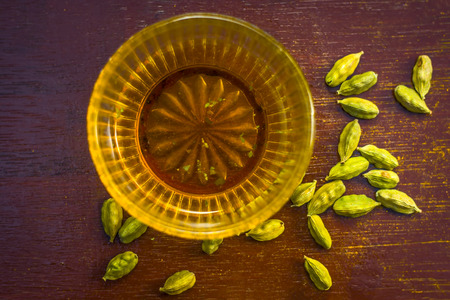 Water of green cardamom,Elettaria cardamomum on wooden surface.の写真素材