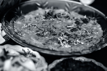 Close up of Dal makhani an Indian meal dish for lunch with sliced cucumber,onions and hari chutney with roti and white Khichdi.の写真素材