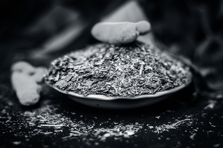 Powder of Indian lilac,Azadirachta indica in a glass plate with its leaves and raw underpowered turmeric.の写真素材