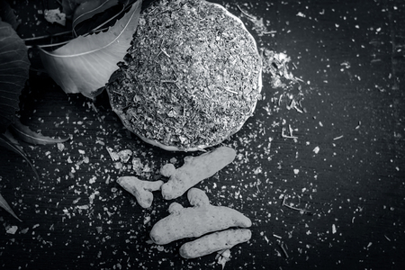 Powder of Indian lilac,Azadirachta indica in a glass plate with its leaves and raw underpowered turmeric.の写真素材