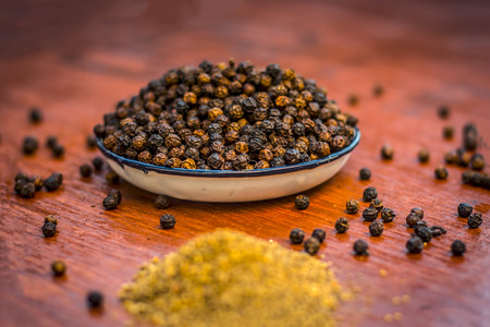 Close up of black pepper,Piper nigrum and its powder.