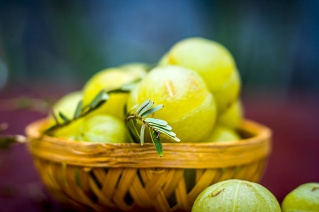 Close up of raw Phyllanthus emblica or Indian goose berry in a basket.の写真素材