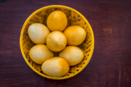 Original hen's eggs in a yellow basket.;の写真素材