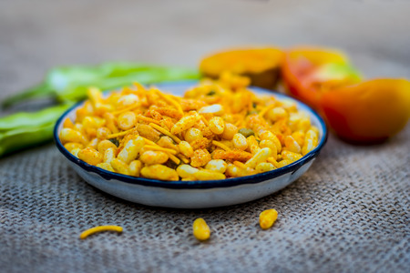 Close up Indian snack mix chevdo in a plate with green chillies.の写真素材
