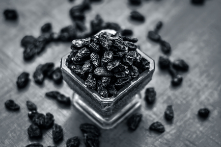 Close up of Black Raisin,Zante currant in a blue colored bowl.の写真素材