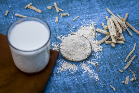 Close up of ayurvedic herb   satavari,Asparagus racemosus with its powder and root with milk glass.の写真素材