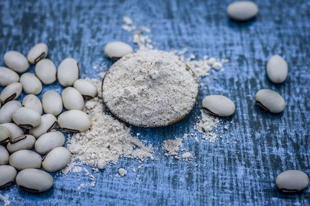 Close up of ayurvedic herb kuanch,cowhage,Mucuna pruriens with powder.