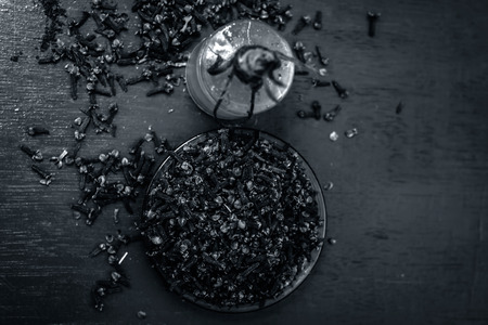Close up of clove with its oil and powder in a white fork.の写真素材