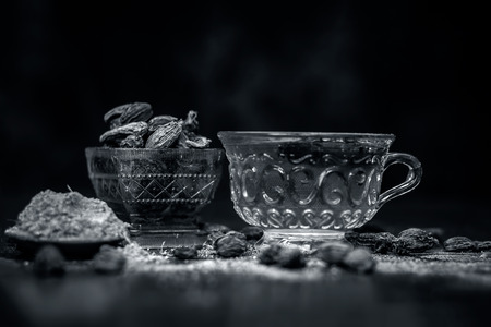 Close up of tea of Black cardamom with its powder and raw whole black cardamom.の写真素材