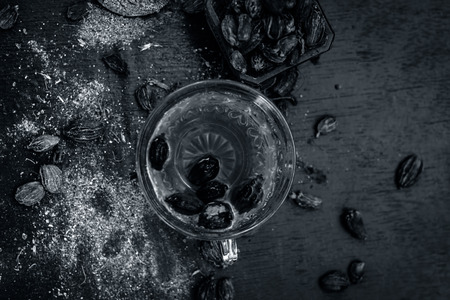 Close up of tea of Black cardamom with its powder and raw whole black cardamom.の写真素材