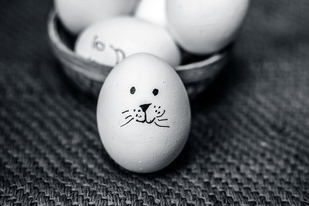 Close up of eggs with drawn funny faces on them.の写真素材
