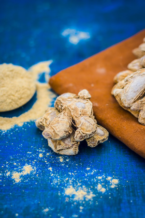 Close up of dry ginger,Zingiber officinale with its powder.の写真素材
