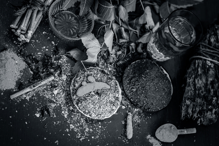 Powder of Indian lilac,Azadirachta indica in a glass plate with its leaves and raw underpowered turmeric.;の写真素材