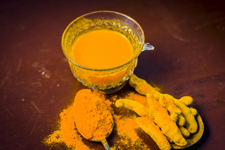 Tea of turmeric,Curcuma longa with its powder.の写真素材